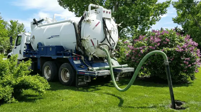 Professional vacuum truck performing residential drainage and septic maintenance in Boston, MA